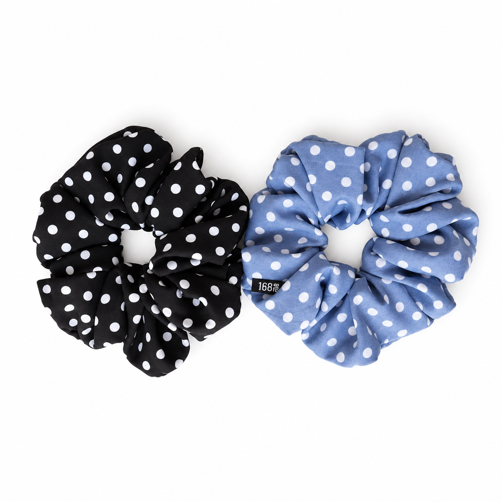 Black and blue polka-dot scrunchies on pure white
